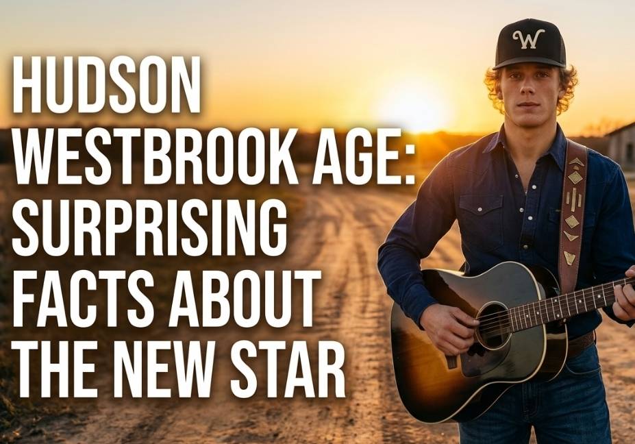 A young country musician holding an acoustic guitar, standing on a dirt road at sunset. He is wearing a dark blue denim button-up shirt, blue jeans, and a dark baseball cap with a white "W" logo. On the left side of the image, bold white text reads, "HUDSON WESTBROOK AGE: SURPRISING FACTS ABOUT THE NEW STAR."