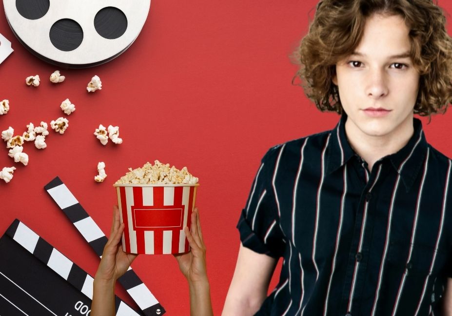 Mason Thames standing next to cinema elements including a bucket of popcorn, a clapperboard, and a film reel against a solid red background.